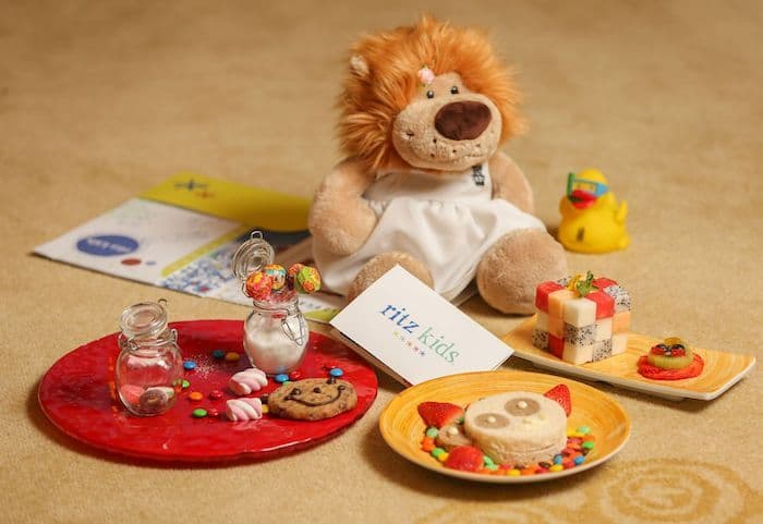 Plateau d'accueil Ritz Kids : peluche lion, biscuits et amuse-bouches préparés pour un enfant