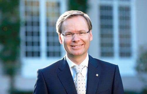 Frank Marrenbach, CEO d'Oetker Collection, en costume devant la façade blanche d'un hôtel