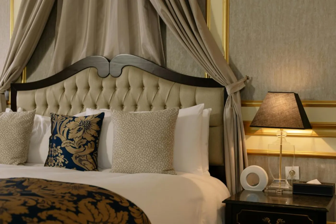 Stylish and cozy bedroom featuring elegant design with plush pillows and decorative details.