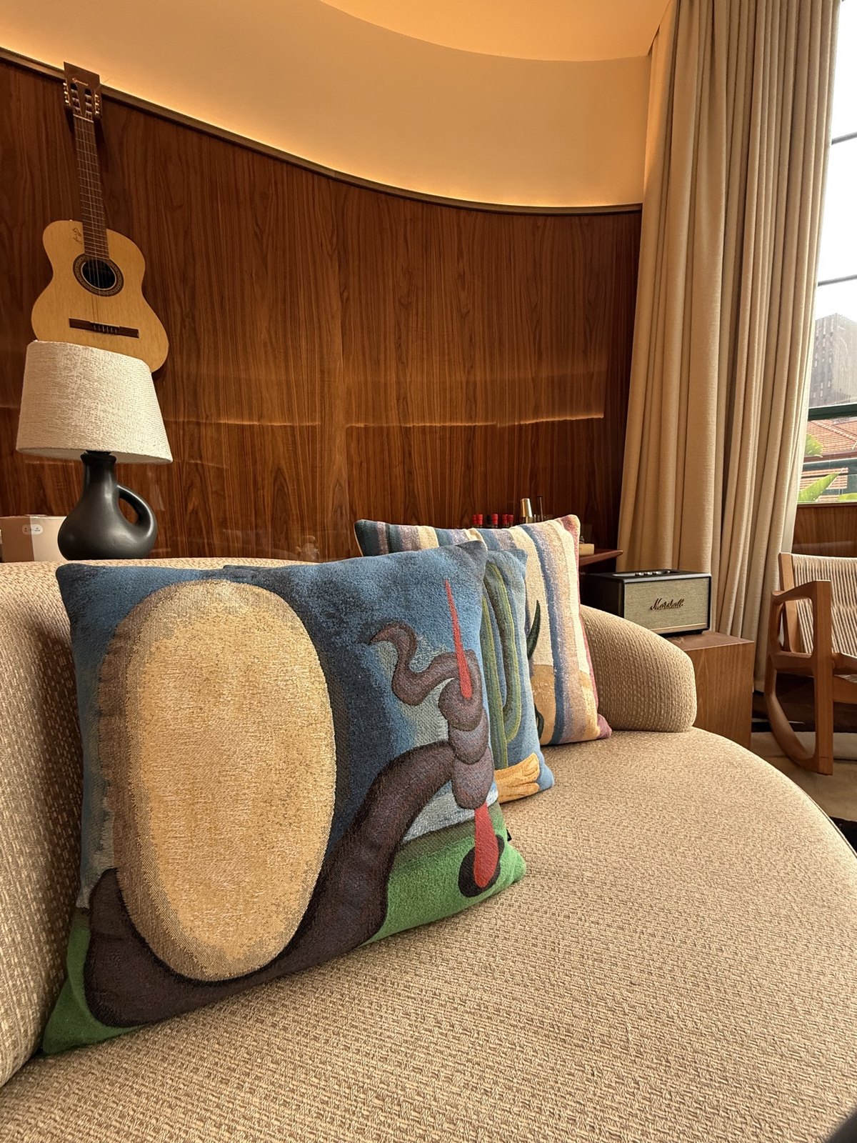 Guitar and artist cushions in a suite at Rosewood São Paulo
