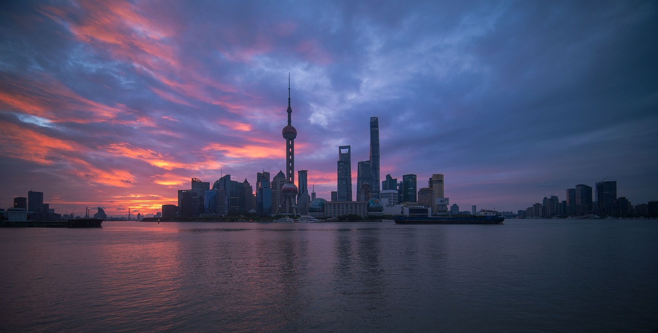 Ligne d'horizon de Shanghai au crépuscule : la tour Perle de l'Orient et les gratte-ciel de Pudong vus du fleuve