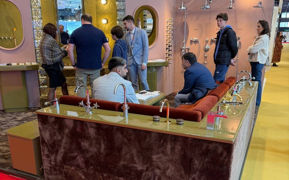 Visitors gathered around a bathroom stand at the EquipHotel trade show, spotted during the DELPORTE HOSPITALITY Luxury Trail