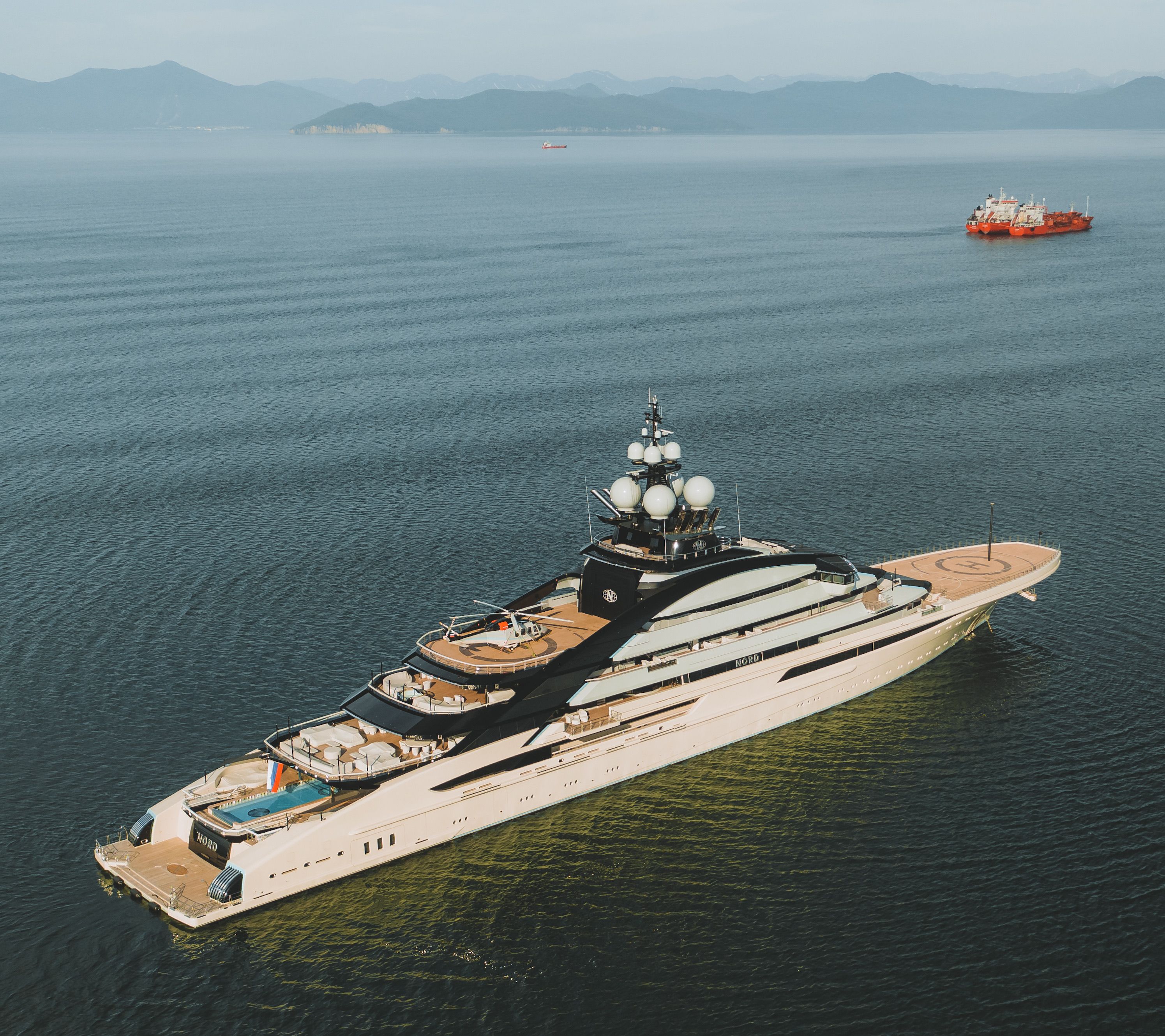 Luxury superyacht anchored offshore, symbol of the new competition between hotels and upscale cruising