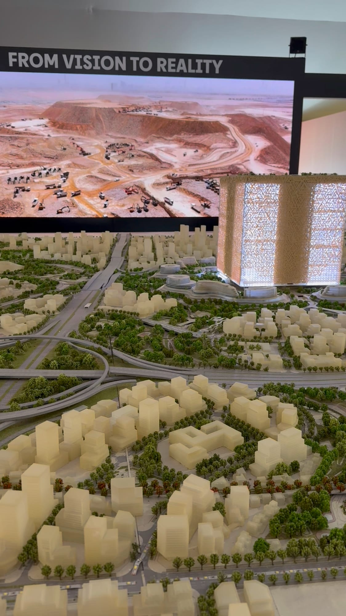 “From vision to reality” screen showing an aerial view of a development project, MIPIM 2026 conference
