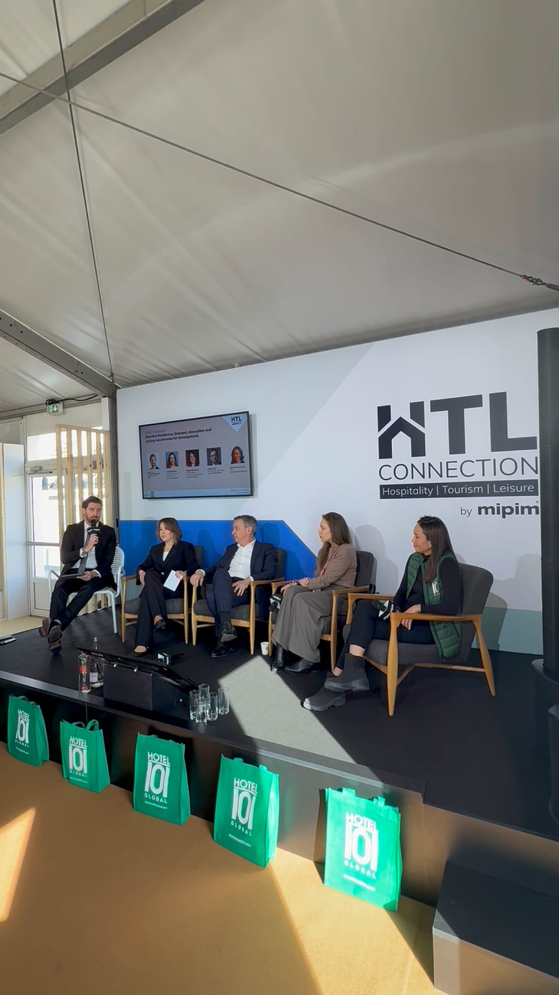 HTL Connections panel at MIPIM 2026, three speakers in discussion in front of the audience