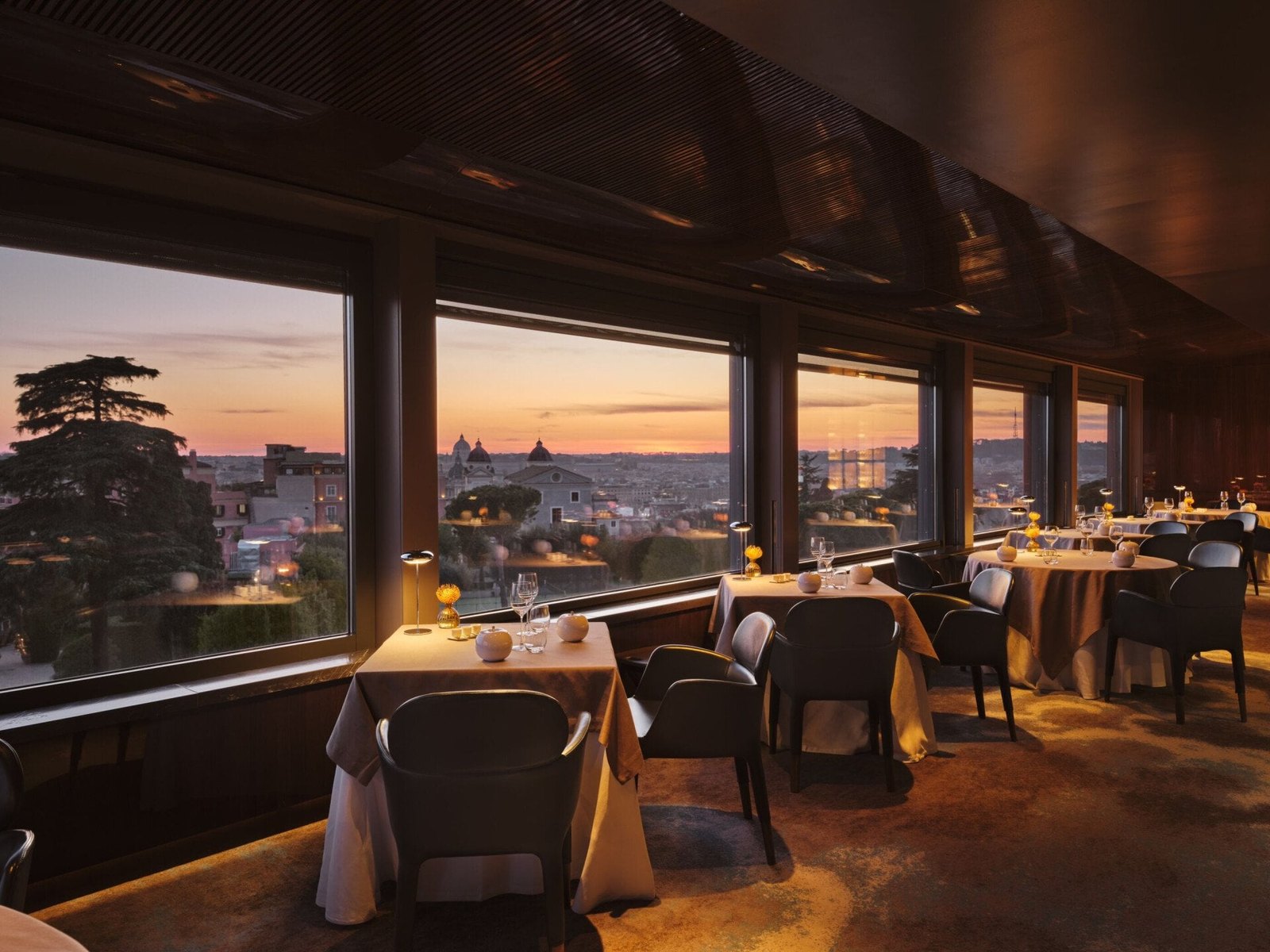 The La Terrazza restaurant on the top floor of Hotel Eden Rome, overlooking the rooftops of Rome at sunset