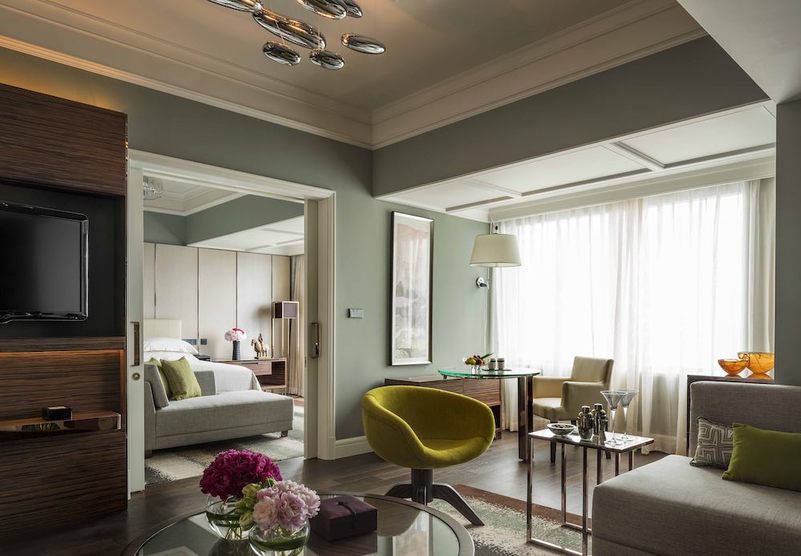 Four Seasons suite: almond green lounge, yellow armchair and the bedroom beyond