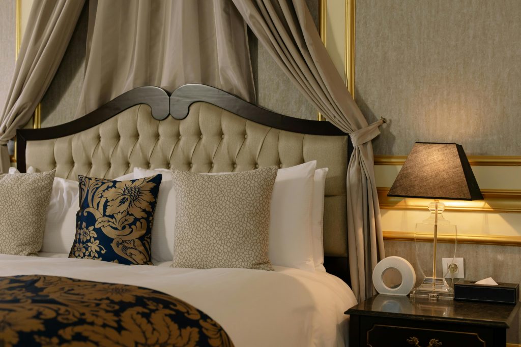 Stylish and cozy bedroom featuring elegant design with plush pillows and decorative details.